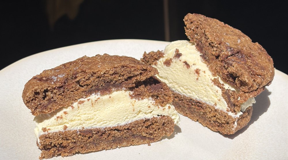 Two halves of a Sol Food chocolate chip cookie ice cream sandwich