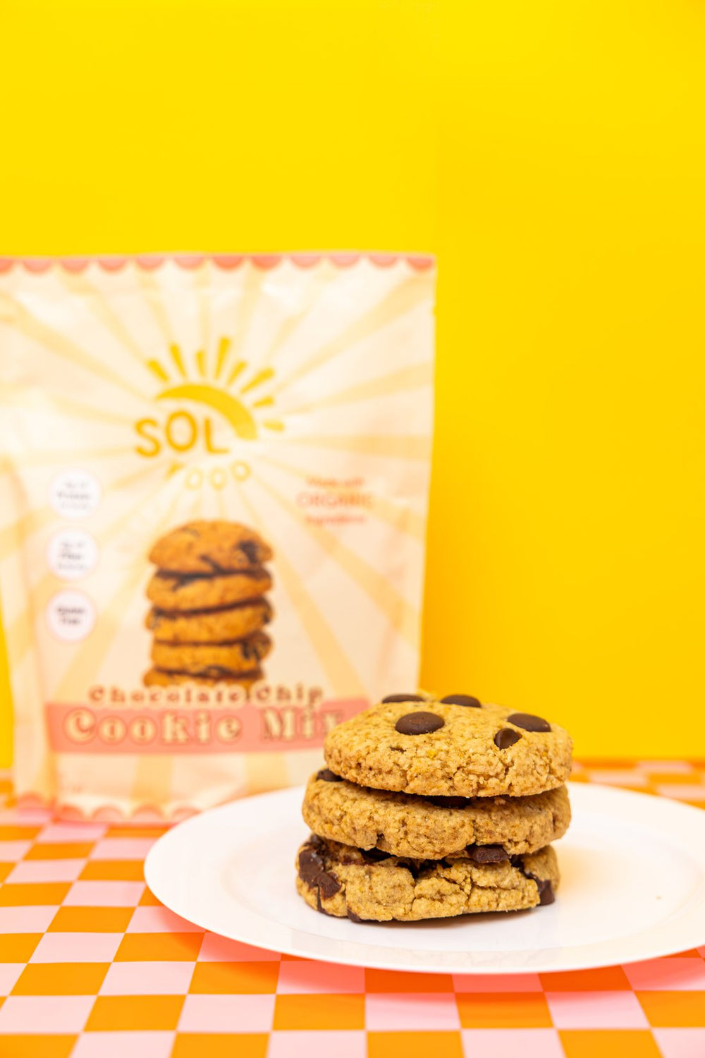 A plate of Sol Food chocolate chip cookies in front of a bag of Cookie Mix