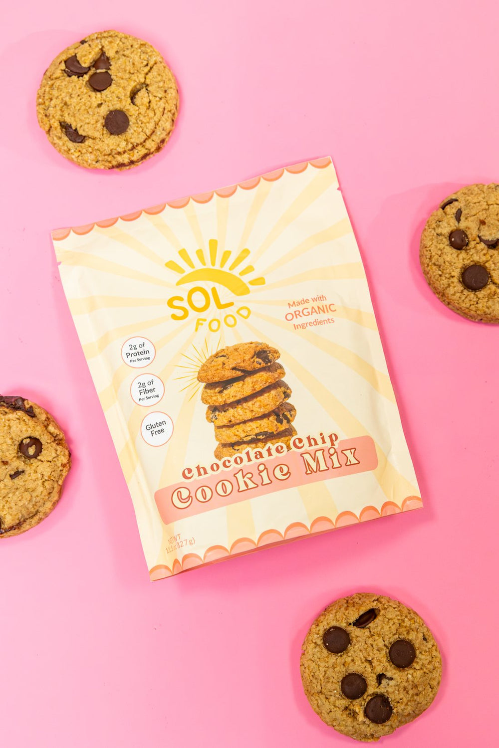 A bag of Sol Food Chocolate Chip Cookie Mix surrounded by baked cookies